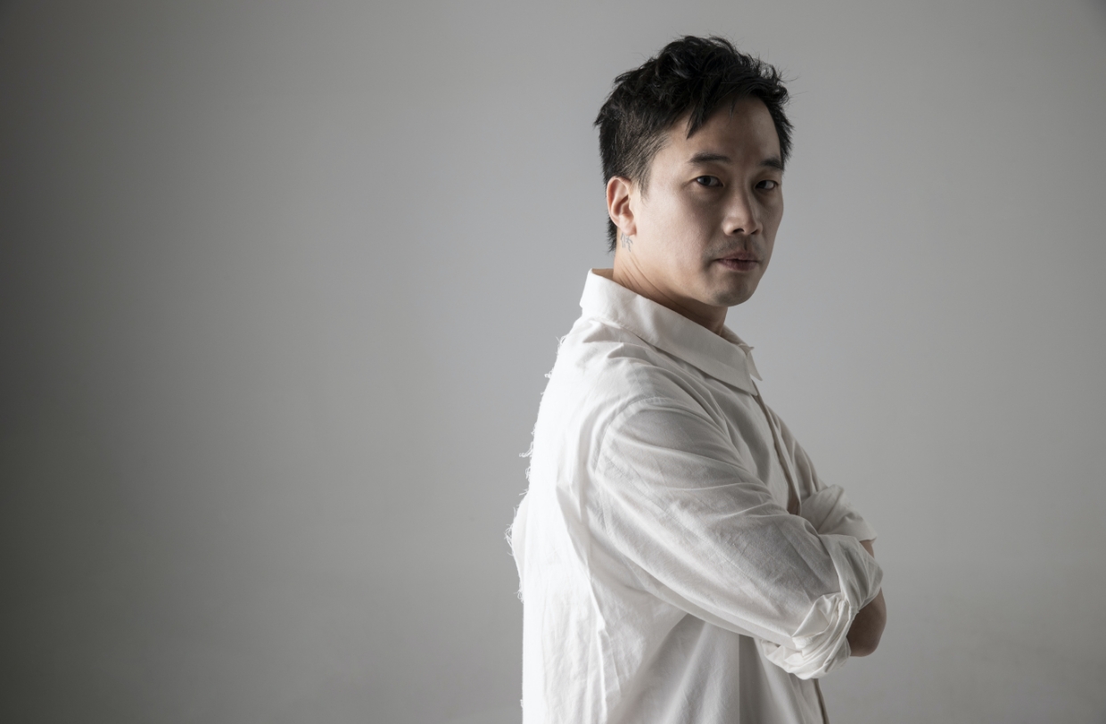 Music director Jaeil Jeong crossed arms in a white shirt