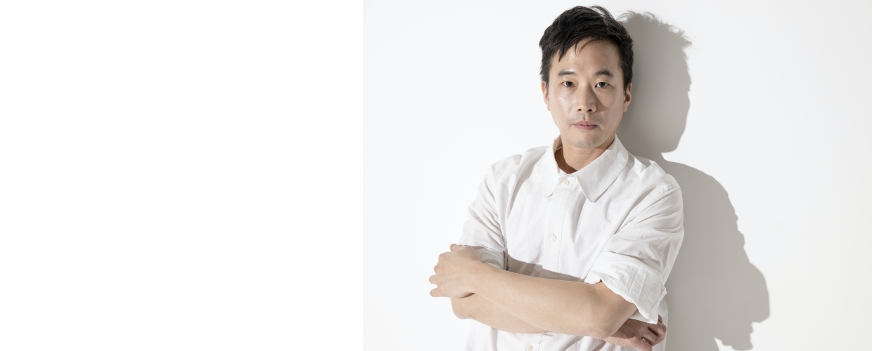 Music director Jaeil Jeong looking straight ahead with his arms crossed