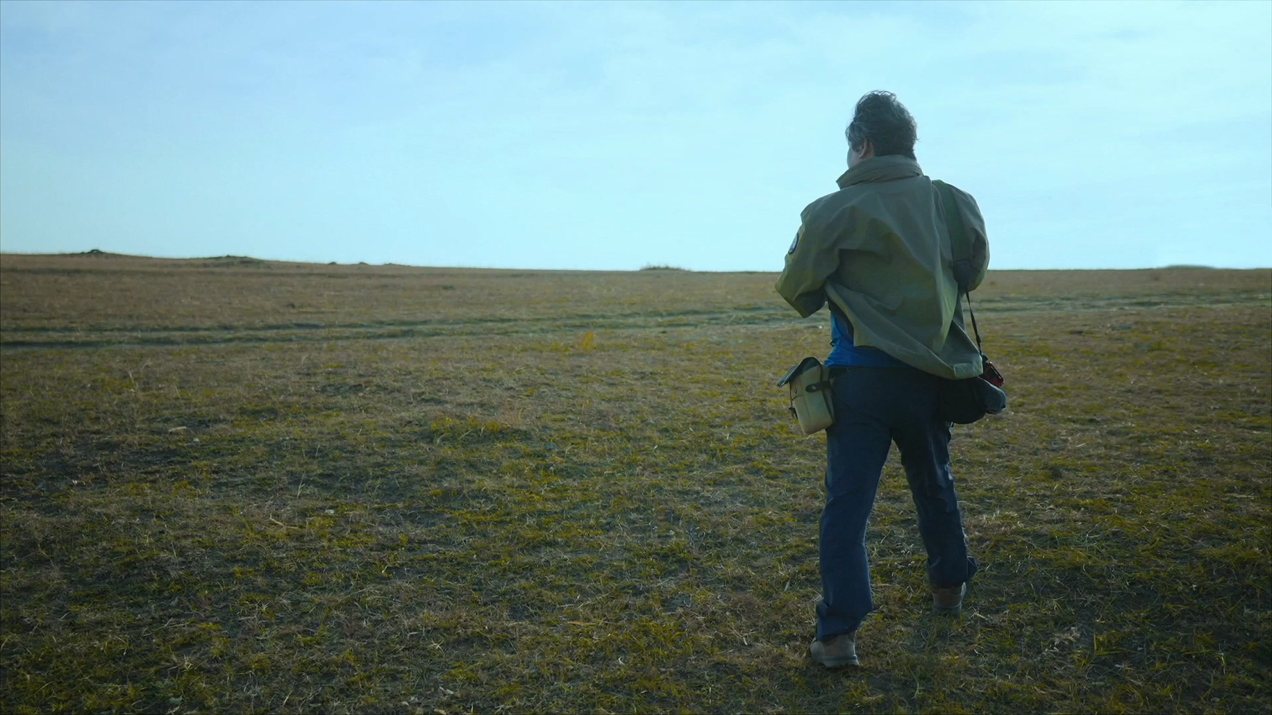 Writer Wang Jingchun standing in the field