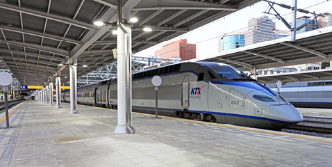 A horizontal photo of a KTX train made by Hyundai Rotem waiting on a train station platform