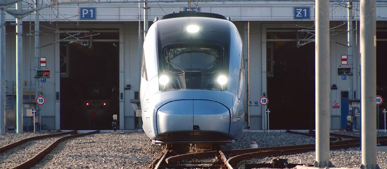 Photo of a silver high-speed train waiting on the track
