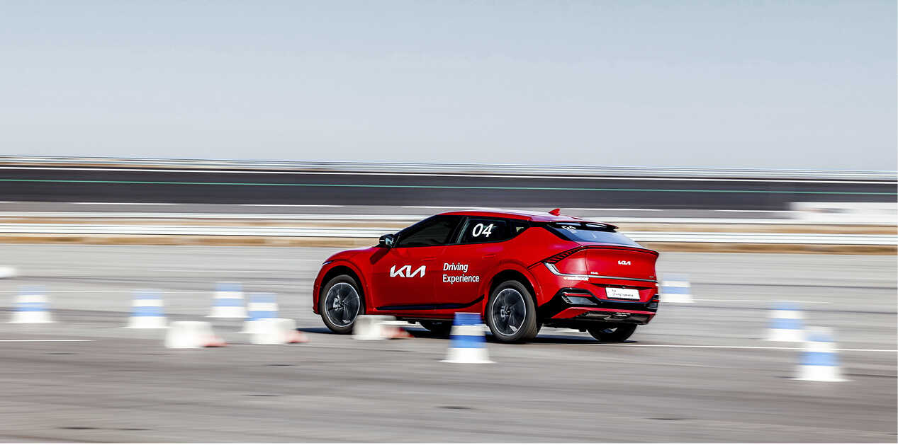 EV6 GT driving in a slalom across a rubber cone
