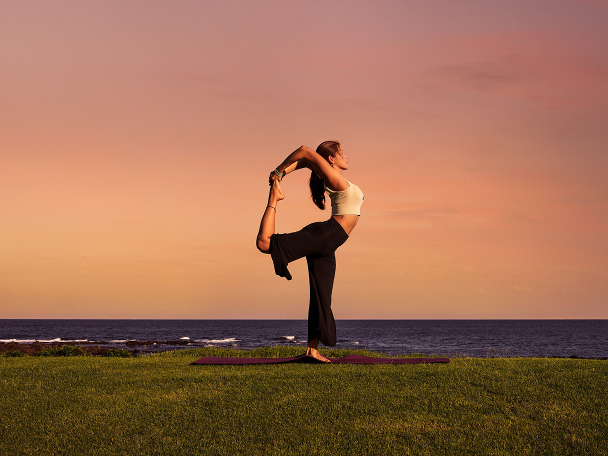 A woman yoga in the background of the sea