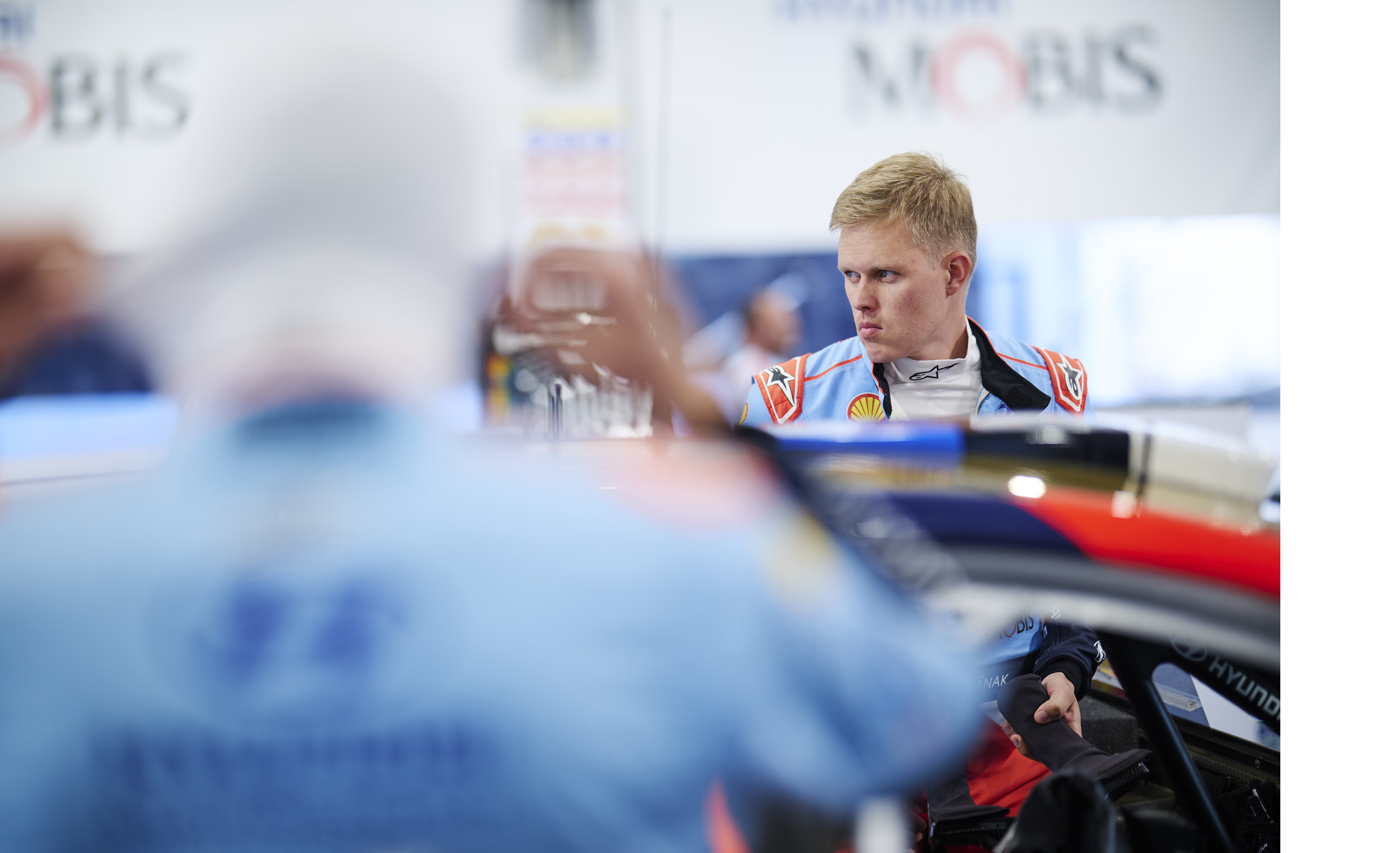 Hyundai team driver Ott Tänak standing next to a rally car