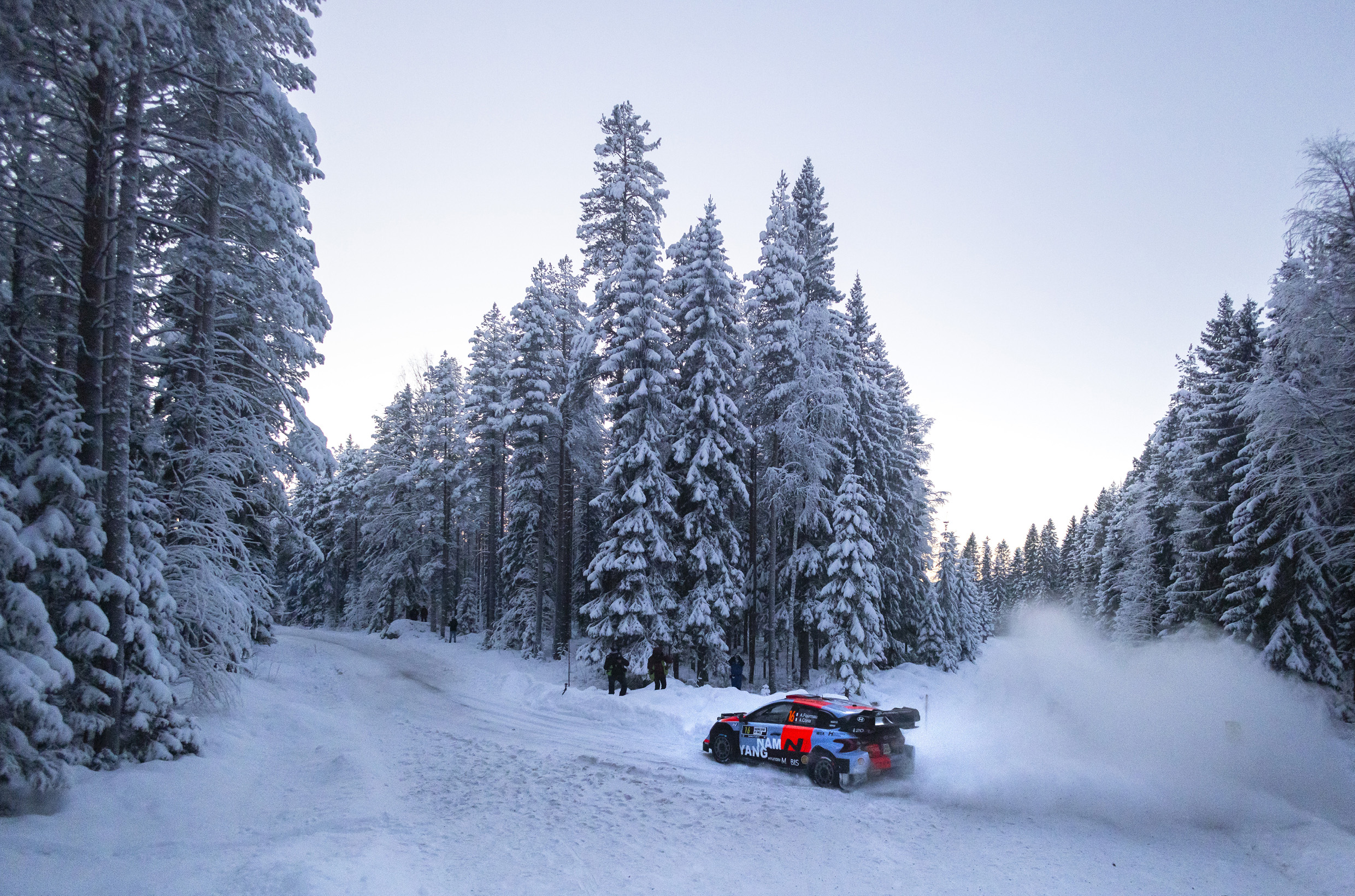 A Hyundai i20N Rally1 Vehicle Riding Through the Snow