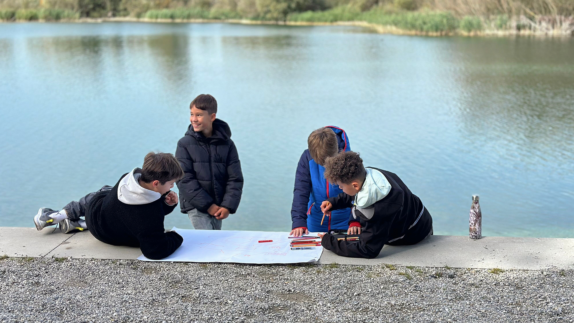 Children drawing pictures on a beach