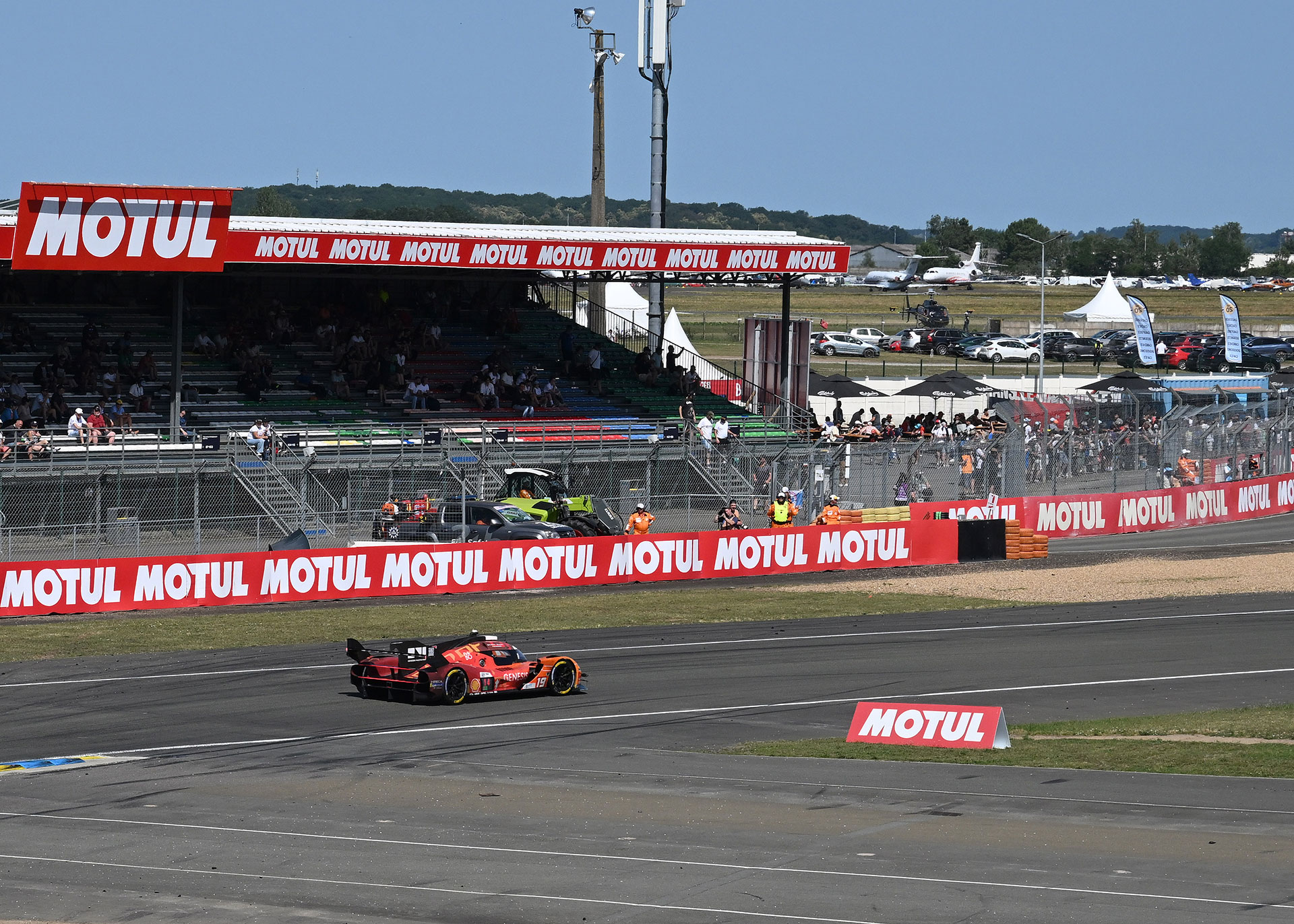 The GMR-001 #19 car passing along the circuit.