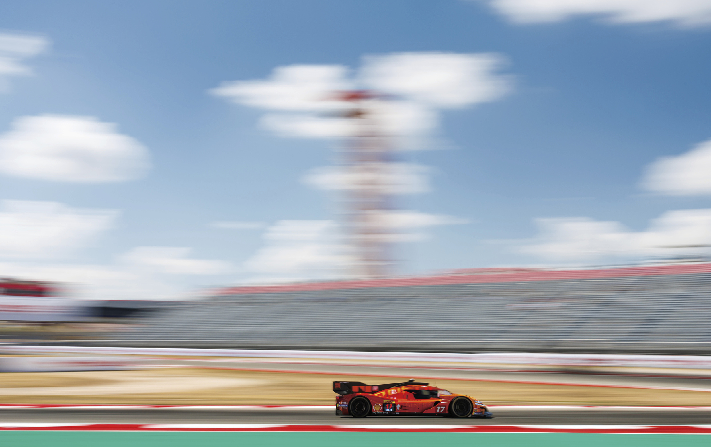 A scene of a Genesis Magma racing car in motion