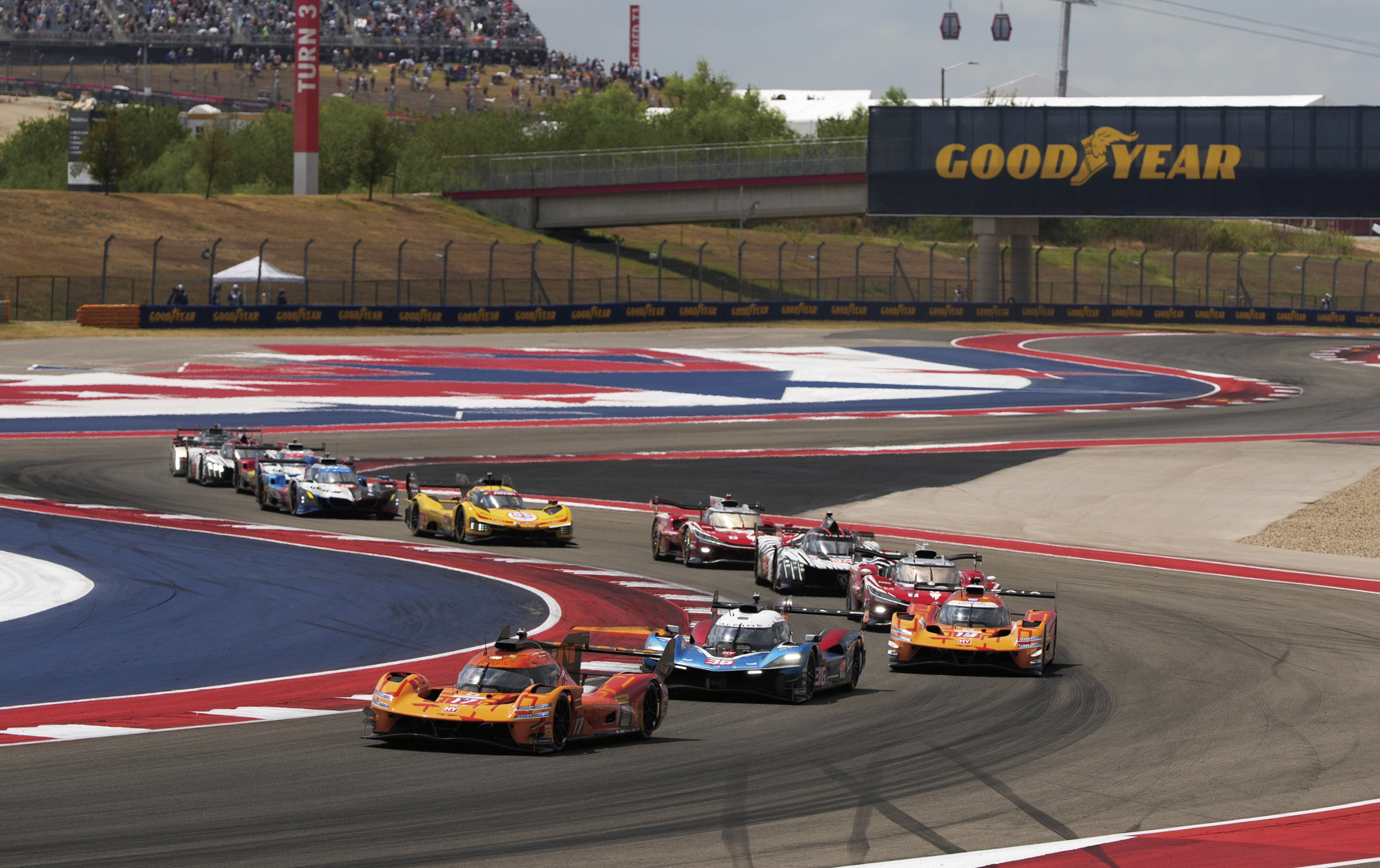 Several cars racing on a track