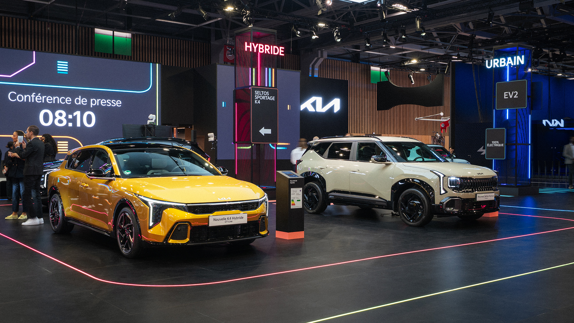 Yellow K4 Hybrid GT-Line and sand Seltos Hybrid at Kia booth