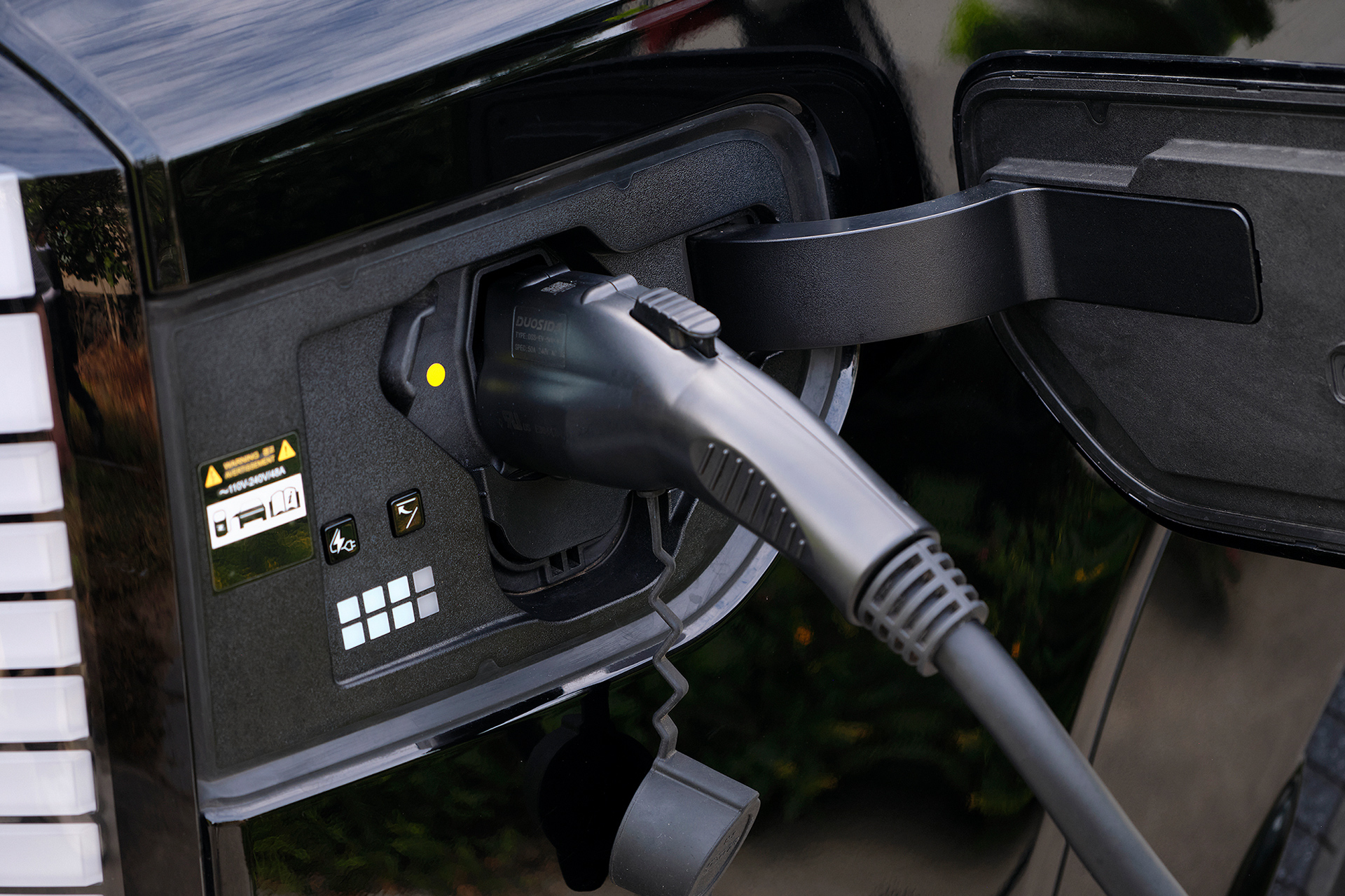 Charging connector plugged into an electric vehicle