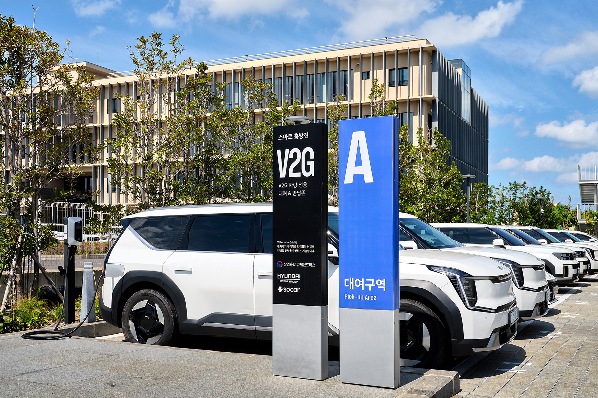 Electric vehicles parked in a dedicated V2G vehicle rental and return zone